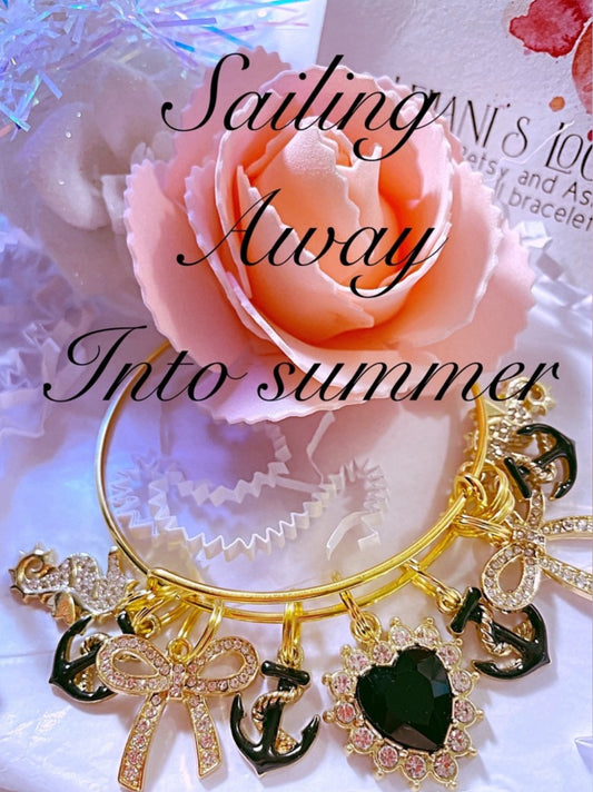 Anchor gold charm bangle bracelet with black and gold anchors,